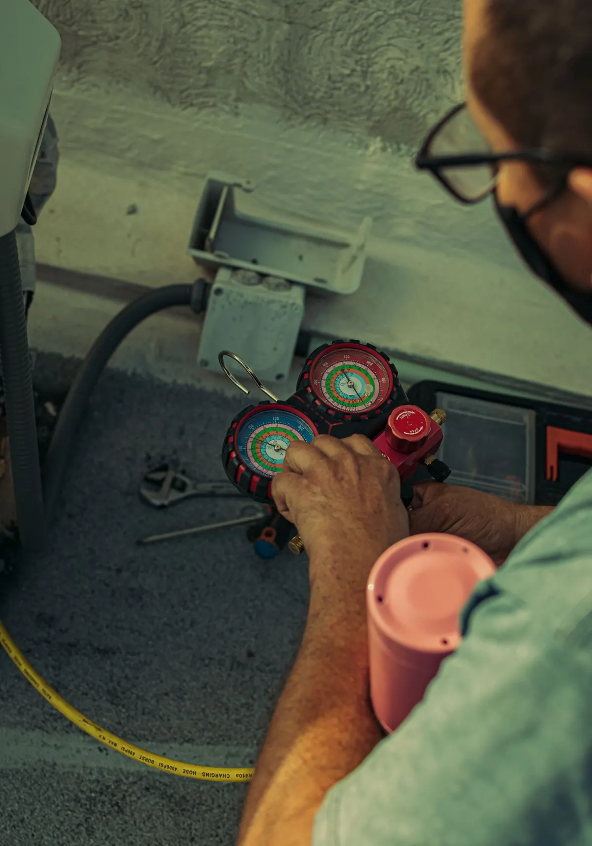 Summit Air technician adjusting a refrigerant gauge on a Boise rooftop unit